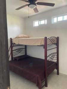 a bunk bed in a room with a ceiling fan at Quinta Colinas Oaxtepec in Oaxtepec