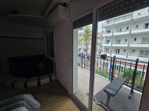 a room with a view of a balcony at Excelente Apartamento de Lujo in Calafell