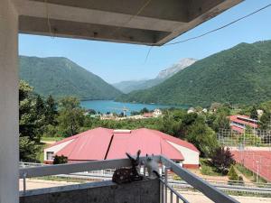 a large red roof with a view of a lake at Apartment ONE in Plužine +5 photos