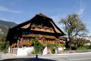 a large building with a clock on the top of it at Hotel Restaurant Hirschen in Interlaken
