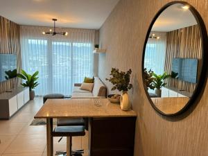 a living room with a table and a mirror at Luxury 1BR Condo Stunning Views in San José +20 photos