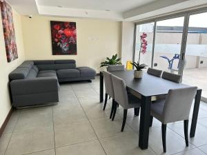 a living room with a table and a couch at Luxury 1BR Condo Stunning Views in San José