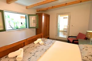 Postel nebo postele na pokoji v ubytování Luka's House - ZF Hvar