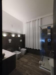a bathroom with a toilet and a sink and a shower at Il Ginepro del Campidano in Nuraminis