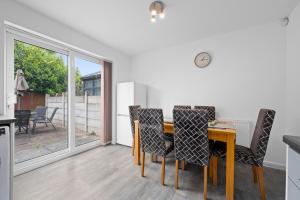 ein Esszimmer mit einem Holztisch und Stühlen in der Unterkunft Three Bedroom House by Brookland Stays Serviced Accommodation Short Lets Wigan with Free WiFi in Hindley + 5 Fotos