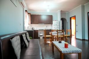 a kitchen and dining room with a table and chairs at Gega's Apartment in Gjirokastër