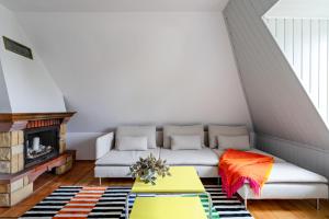 a living room with a couch and a fireplace at Santorini II - City & Beach by Lion Apartments Sopot in Sopot