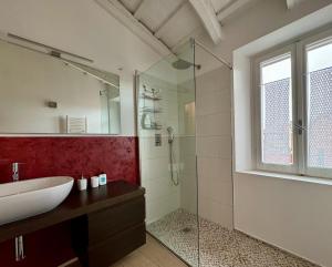 a bathroom with a sink and a glass shower at al Centro di Santarcangelo in Santarcangelo di Romagna