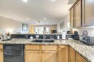 a kitchen with a sink and a microwave at 23-Mile Canal On-Site Condo in Ocean Shores! in Ocean Shores +19 photos