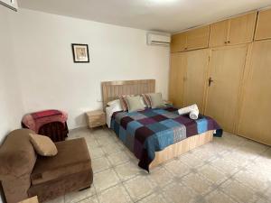 a bedroom with a bed and a couch in it at Dar Al Hajja Fatima in Rabat