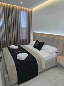 a bedroom with a bed with two towels on it at Aventus Luxury Villa in Rrushkull +35 photos