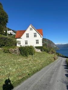 a white house on the side of a road at Stryn Panorama in Stryn