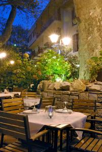 a restaurant with tables and chairs and a building at Gastronomy Hotel Kritsa in Portaria
