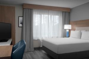 a hotel room with a bed and a television at Candlewood Suites Annapolis by IHG in Annapolis