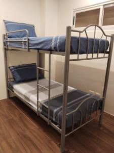 a couple of bunk beds in a room at Matina Enclaves Bldg D 2Bedroom with balcony and view in Davao City