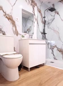 a bathroom with a white toilet and a mirror at Suite Room With Balcony and Douro Views in Valbom