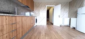 a kitchen with wooden cabinets and a white refrigerator at Suite Room With Balcony and Douro Views in Valbom