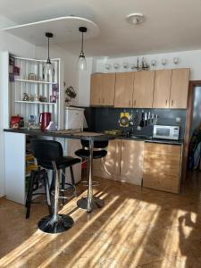a kitchen with a counter and stools in it at Passat12 in Sunny Beach