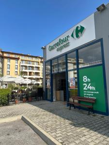 a store front with a bench in front of a building at Passat12 in Sunny Beach +19 photos