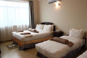 מיטה או מיטות בחדר ב-Grace Land Hotel