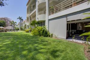 a green yard in front of a building at El Tigre, Green Bay I Shared Pool in Nuevo Vallarta 
