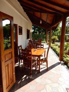 a wooden table and chairs on a patio at Belle Amie Self Catering in La Digue