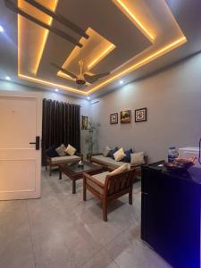 a living room with couches and a ceiling at Private in Dargai