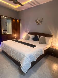 a bedroom with a large bed with white sheets at Private in Dargai +11 photos