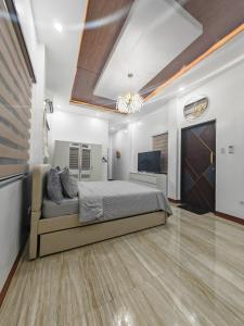 a bedroom with a bed and a flat screen tv at Nature Retreat Mantayupan Waterfalls in Barili