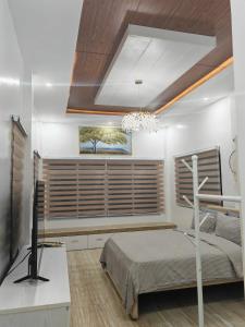 a bedroom with a bed and a large window at Nature Retreat Mantayupan Waterfalls in Barili
