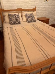 a bed with two pillows on top of it at El retoño in San Antonio de Areco