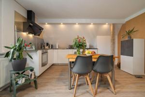 a kitchen with a wooden table and chairs in a room at Ferienwohnung-Am-Hoepen in Rechlin