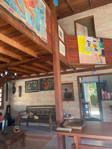 a living room with a couch and a wooden ceiling at InnFloripa - Pousada no Campeche in Florianópolis