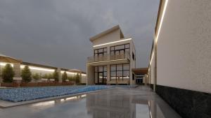 a house with a swimming pool in front of a building at Nabila Chalet in Sowayma