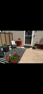 a patio with flowers and a table and chairs at The Kilbourn House in Tomah +19 photos