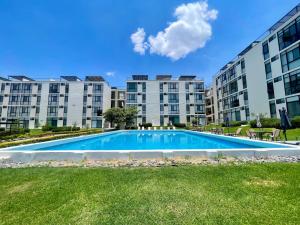 a swimming pool in front of some apartment buildings at Condo PH Lago Luna, Chante in Chantepec