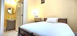 a small bedroom with a bed and a sink at Perfect Location! Quiet-Spacious-2 Bed-2 Bath in Windsor