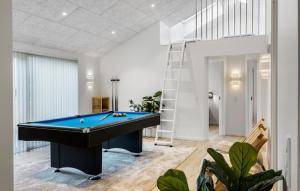 a pool table in a living room with a ladder at Cozy Home In Saltum With Sauna in Saltum +22 photos