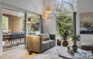 a living room with a couch and a table at Cozy Home In Saltum With Sauna in Saltum