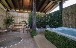a jacuzzi tub in a garden with a wooden roof at Amazing Home In Montefiascone in Montefiascone