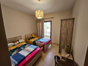 a bedroom with two beds and a window at Private villa - Azha Ein Sokhna - Families only in Ain Sokhna +12 photos