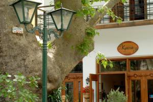 a street light in front of a building with a tree at Gastronomy Hotel Kritsa in Portaria