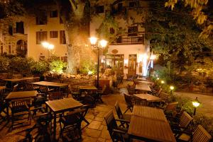 an outdoor restaurant with tables and chairs at night at Gastronomy Hotel Kritsa in Portaria
