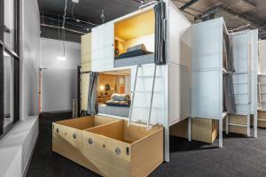 a room with bunk beds with a bed in it at Tequila Sunrise Podstel Brisbane in Brisbane