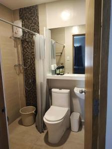 a bathroom with a toilet and a sink and a shower at Cebu Park Residence Condominium in Cebu City