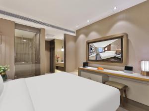 Rúm í herbergi á Crystal Orange Hotel Shanghai Hongqiao Jinhui Road