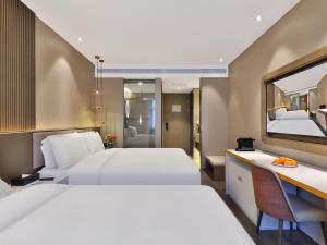 Rúm í herbergi á Crystal Orange Hotel Shanghai Hongqiao Jinhui Road