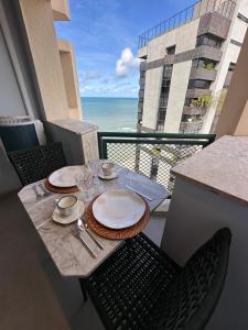 un tavolo su un balcone con vista sull'oceano di Apart-Hotel Costa Mar - luxo- beira mar a Recife