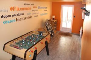 Pokój ze stołem do gry w piłkarzyki i ścianą w obiekcie L'Alisier Chantant w mieście Bourron-Marlotte