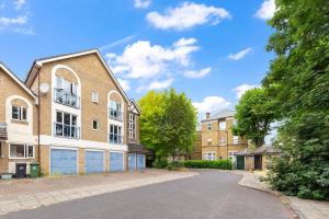 an empty street in front of a brick building at Bright modern Flat near tower bridge in London